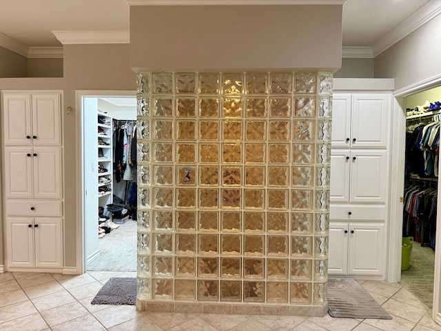 5 Muirfield Dr, Odessa, TX 79762 - bathroom featuring crown molding, tile patterned flooring, a walk in closet, and walk in shower