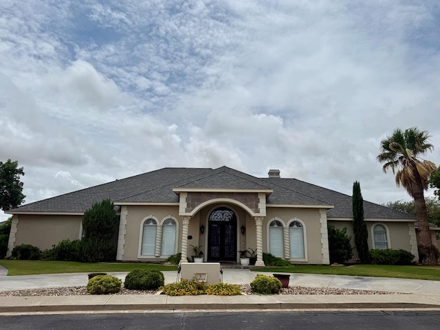 5 Muirfield Dr, Odessa, TX 79762 - mediterranean / spanish home featuring french doors, stucco siding, and roof with shingles