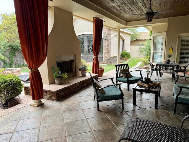5 Muirfield Dr, Odessa, TX 79762 - view of patio / terrace featuring a large fireplace, outdoor dining area, ceiling fan, and french doors