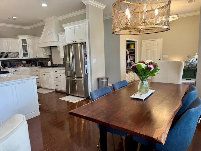 5 Muirfield Dr, Odessa, TX 79762 - dining room featuring dark wood-style flooring, ornamental molding, recessed lighting, and a chandelier