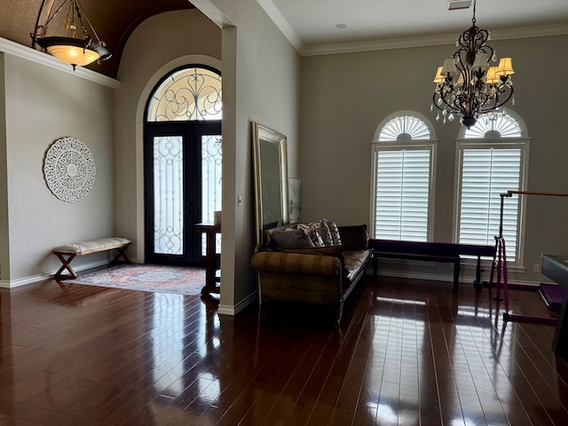 5 Muirfield Dr, Odessa, TX 79762 - entrance foyer featuring a chandelier, dark wood-style flooring, crown molding, and a towering ceiling
