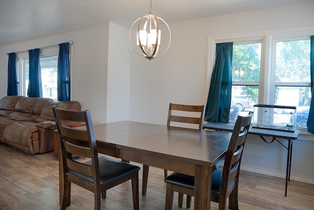 700 NE 2nd St, Andrews, TX 79714 - dining space with a chandelier, wood finished floors, and healthy amount of natural light
