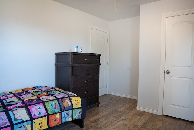 700 NE 2nd St, Andrews, TX 79714 - bedroom featuring dark wood-style flooring and baseboards