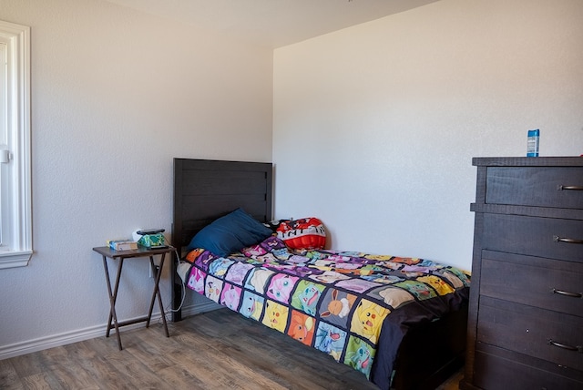 700 NE 2nd St, Andrews, TX 79714 - bedroom with wood finished floors and baseboards