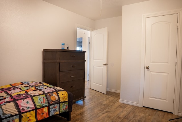 700 NE 2nd St, Andrews, TX 79714 - bedroom featuring dark wood finished floors and baseboards