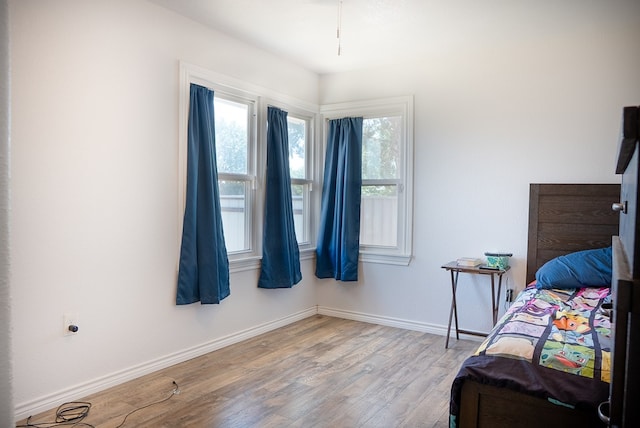 700 NE 2nd St, Andrews, TX 79714 - bedroom featuring light wood finished floors and baseboards