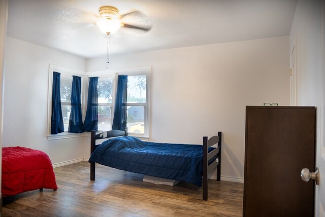 700 NE 2nd St, Andrews, TX 79714 - bedroom with wood finished floors and baseboards