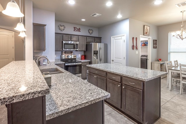 2004 Boise Dr, Odessa, TX 79762 - kitchen featuring appliances with stainless steel finishes, dark brown cabinets, a sink, a chandelier, and recessed lighting