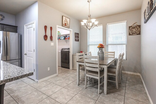 2004 Boise Dr, Odessa, TX 79762 - dining area featuring washer / clothes dryer, a chandelier, baseboards, and light tile patterned flooring