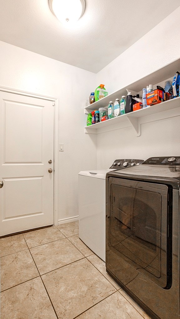 2004 Boise Dr, Odessa, TX 79762 - washroom with washer and dryer and light tile patterned floors