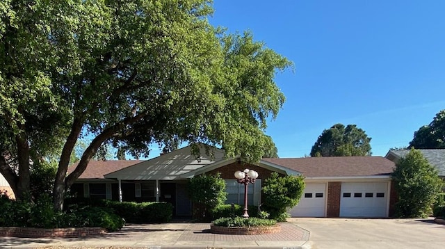 ranch-style house featuring an attached garage and driveway