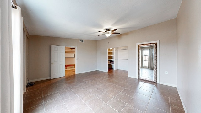 unfurnished room featuring ceiling fan and light tile patterned floors