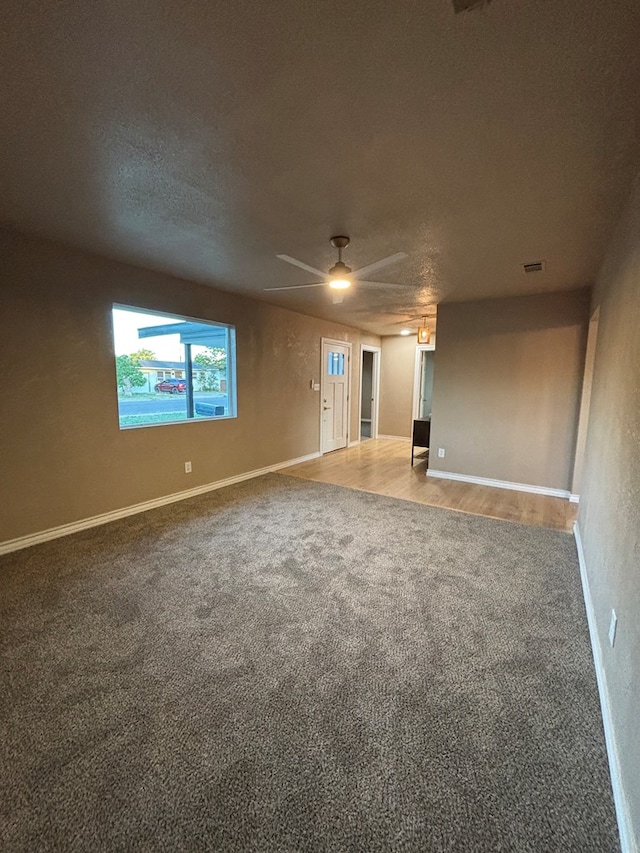 314 SW 11th Pl, Andrews, TX 79714 - spare room with carpet, ceiling fan, a textured ceiling, and baseboards