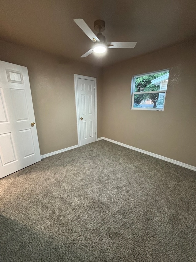 314 SW 11th Pl, Andrews, TX 79714 - unfurnished bedroom featuring carpet, baseboards, and a ceiling fan