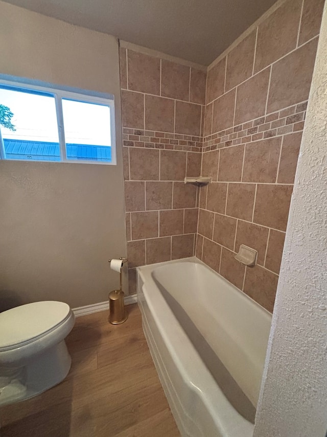 314 SW 11th Pl, Andrews, TX 79714 - full bathroom with toilet, wood finished floors, and baseboards