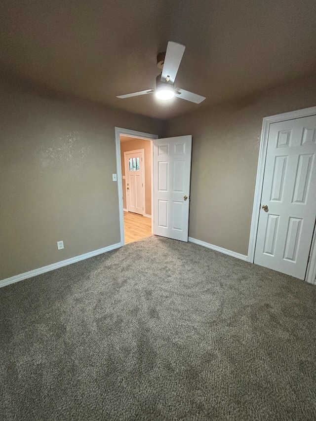 314 SW 11th Pl, Andrews, TX 79714 - unfurnished bedroom with carpet flooring, baseboards, and ceiling fan