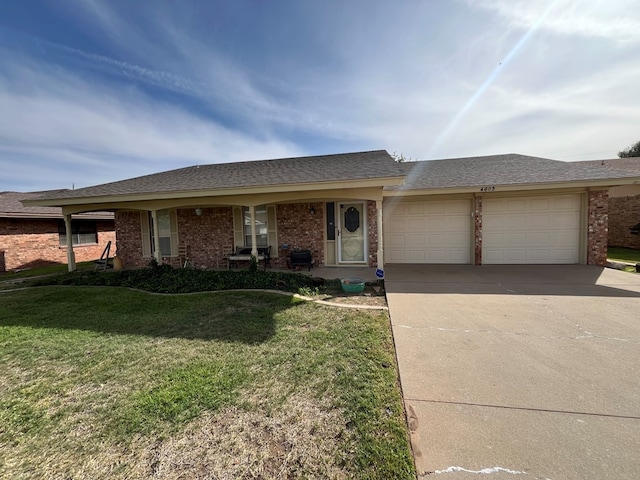 4605 Redbud Ave, Odessa, TX 79762 - single story home featuring an attached garage, a front lawn, brick siding, driveway, and a shingled roof