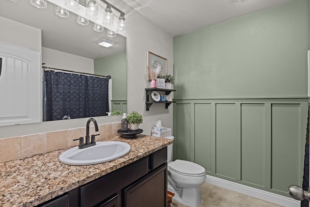 800 94th, Odessa, TX 79765 - bathroom featuring vanity, toilet, tile patterned flooring, and curtained shower
