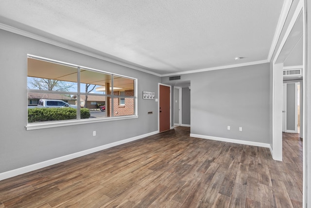 2616 E 21st St, Odessa, TX 79761 - spare room with a textured ceiling, crown molding, wood finished floors, and baseboards