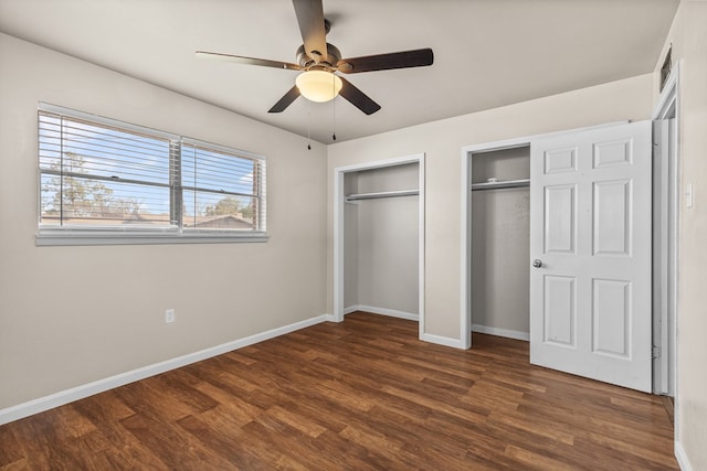 2616 E 21st St, Odessa, TX 79761 - unfurnished bedroom with two closets, wood finished floors, baseboards, and a ceiling fan