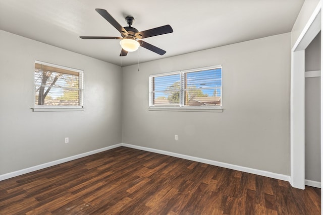2616 E 21st St, Odessa, TX 79761 - unfurnished bedroom with baseboards, dark wood-type flooring, and a ceiling fan
