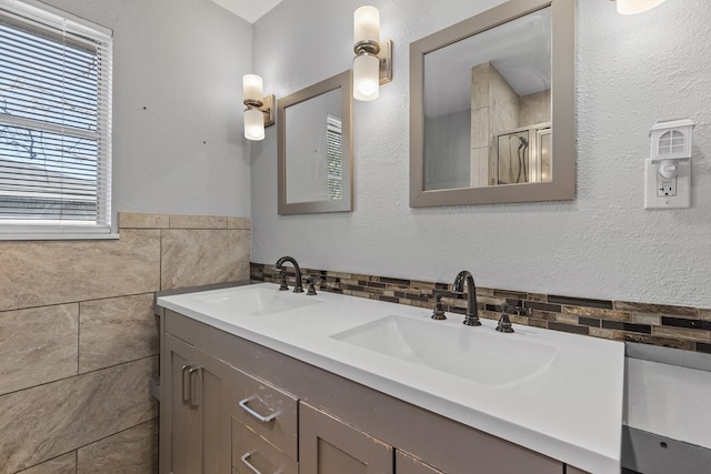 2616 E 21st St, Odessa, TX 79761 - bathroom featuring double vanity, tile walls, and a shower with shower door