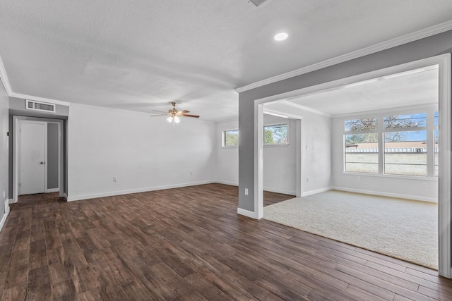 2616 E 21st St, Odessa, TX 79761 - unfurnished living room featuring a ceiling fan, dark wood finished floors, ornamental molding, baseboards, and a textured ceiling