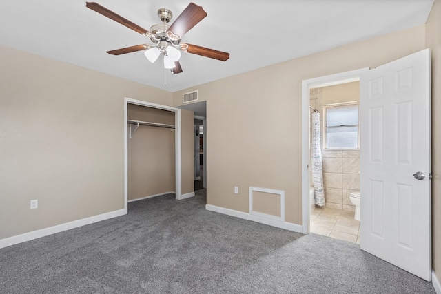2616 E 21st St, Odessa, TX 79761 - unfurnished bedroom with carpet, baseboards, connected bathroom, a closet, and a ceiling fan