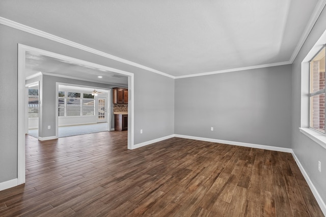 2616 E 21st St, Odessa, TX 79761 - unfurnished room with baseboards, dark wood-style flooring, and crown molding