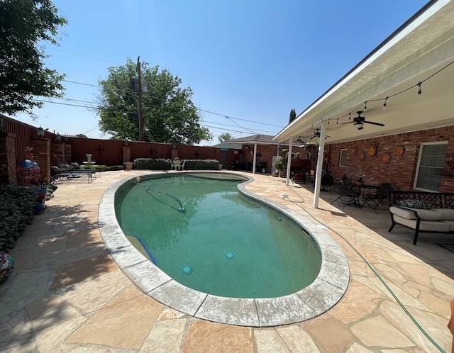 view of swimming pool featuring a patio, a fenced in pool, a ceiling fan, and a fenced backyard