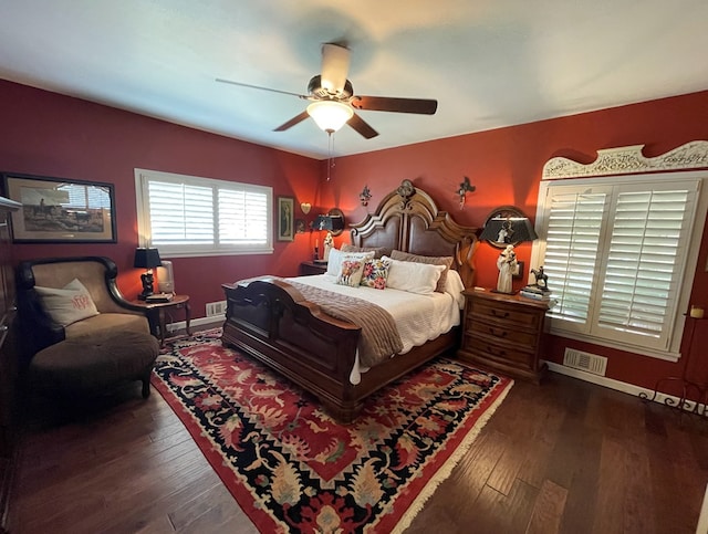 bedroom with baseboards, wood-type flooring, a ceiling fan, and visible vents