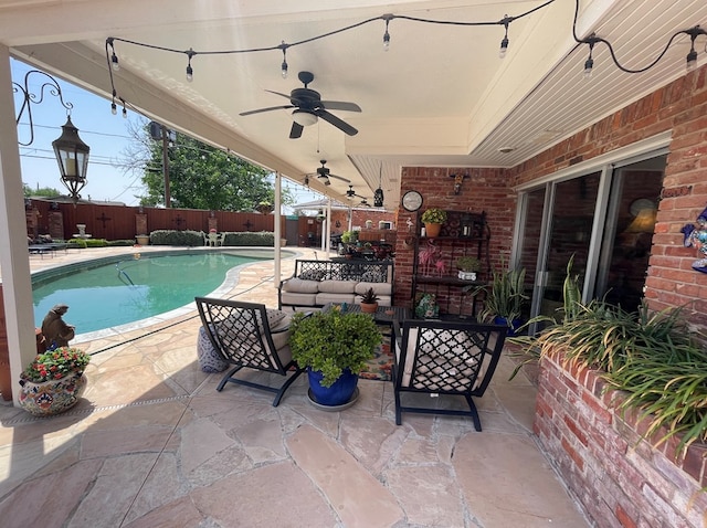 view of patio with an outdoor hangout area, a ceiling fan, a fenced in pool, and a fenced backyard