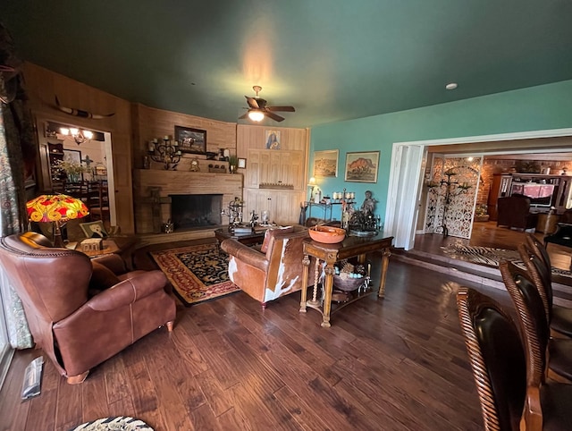 living room featuring ceiling fan, wood finished floors, and a fireplace