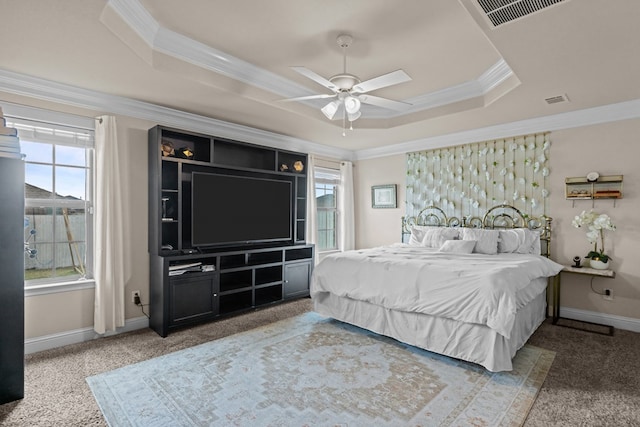609 E 96th Ct, Odessa, TX 79765 - carpeted bedroom with a tray ceiling, ornamental molding, multiple windows, baseboards, and a ceiling fan