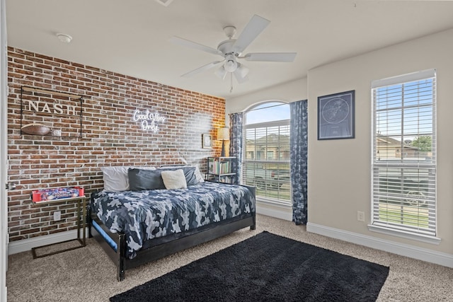 609 E 96th Ct, Odessa, TX 79765 - bedroom featuring brick wall, carpet, baseboards, and ceiling fan