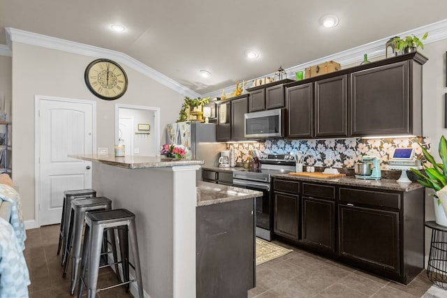 609 E 96th Ct, Odessa, TX 79765 - kitchen with appliances with stainless steel finishes, a breakfast bar, lofted ceiling, ornamental molding, and decorative backsplash