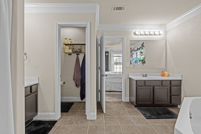 609 E 96th Ct, Odessa, TX 79765 - full bath featuring vanity, ornamental molding, tile patterned floors, a tub, and ensuite bathroom
