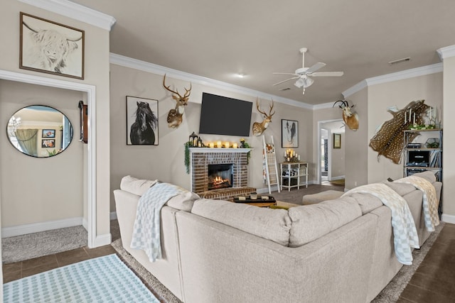 609 E 96th Ct, Odessa, TX 79765 - living room featuring a ceiling fan, crown molding, a fireplace, baseboards, and dark tile patterned flooring
