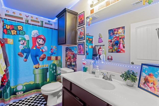 609 E 96th Ct, Odessa, TX 79765 - full bathroom with toilet, vanity, a shower with shower curtain, and tile patterned floors