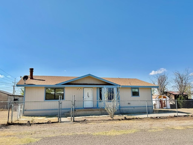 manufactured / mobile home featuring a fenced front yard and a gate