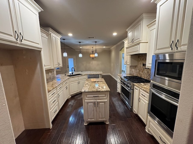 1205 Silverton Dr, Midland, TX 79705 - kitchen with stainless steel appliances, a peninsula, dark wood-style flooring, tasteful backsplash, and recessed lighting