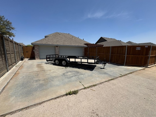 1205 Silverton Dr, Midland, TX 79705 - view of side of property with brick siding, a garage, and a shingled roof