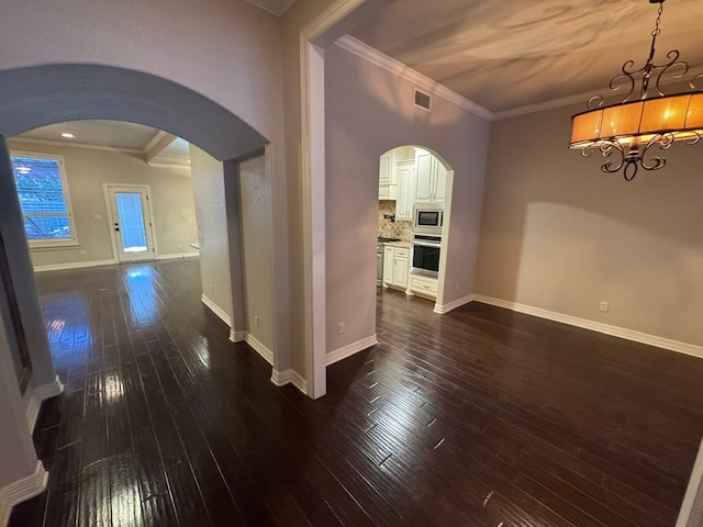 1205 Silverton Dr, Midland, TX 79705 - hall featuring arched walkways, a chandelier, dark wood finished floors, and crown molding