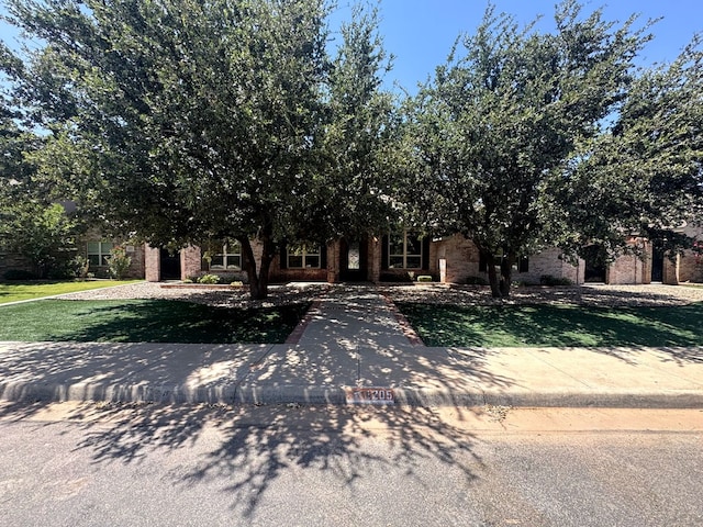 1205 Silverton Dr, Midland, TX 79705 - view of property hidden behind natural elements with brick siding and a front lawn