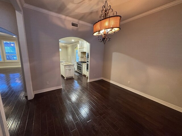 1205 Silverton Dr, Midland, TX 79705 - unfurnished dining area with arched walkways, dark wood-style flooring, crown molding, and a chandelier