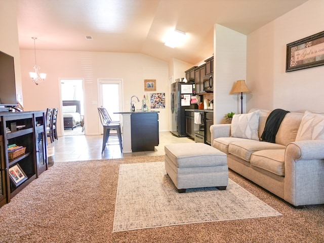 living area with visible vents, vaulted ceiling, light tile patterned flooring, and a chandelier