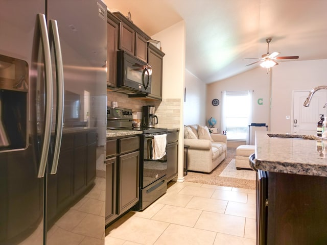 kitchen featuring ceiling fan, light stone countertops, tasteful backsplash, vaulted ceiling, and black appliances