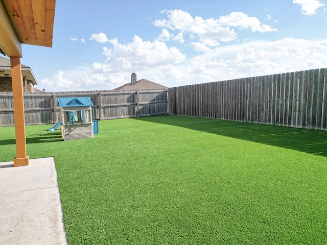 view of yard featuring a playground and a fenced backyard