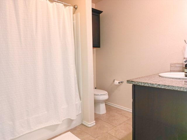 full bath featuring shower / bath combo, tile patterned floors, baseboards, vanity, and toilet