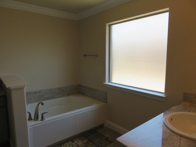 1812 Masquerade Blvd, Odessa, TX 79765 - full bathroom featuring crown molding, a bath, vanity, and baseboards